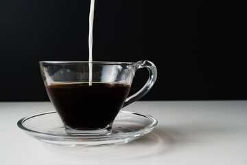 Close uyp of milk being poured into coffee cup
