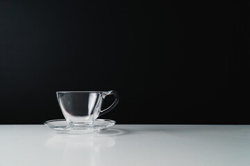 Single glass coffee cup set against black background