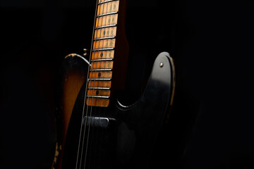 Old guitar with black background - obrazy, fototapety, plakaty