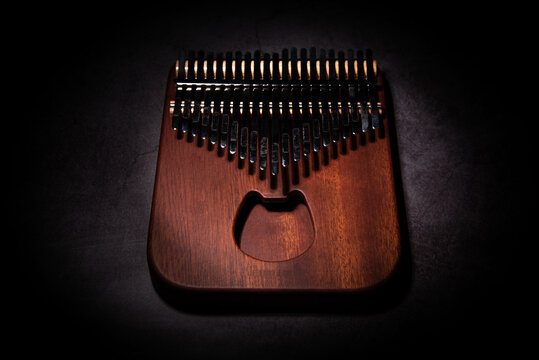 Kalimba or mbira is an African musical instrument. Kalimba is made of wood with metal to create sound. separately on cement floor