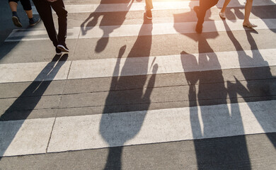 Shadows of people on the crosswalk