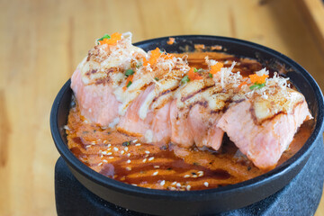 Grilled Salmon sushi with cream salad and spicy sauce placed on a Japanese grill, sushi is a traditional and popular food for Japanese people.