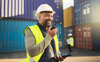 Logistics, radio and a black man in shipping container yard with tablet. Industrial cargo area, happy transport worker talking on walkie talkie in safety gear and working for global freight industry. - obrazy, fototapety, plakaty