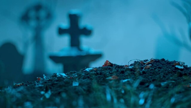 Zombie hand makes okay gesture out of grave. Holiday event halloween concept.