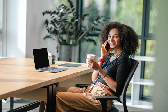 Pretty Young Womna Sitting In The Ofice And Having Morning Coffee