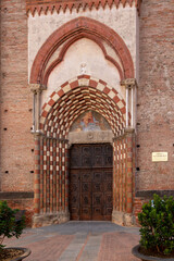 Fototapeta na wymiar Alba, Langhe, Piedmont, Italy - August 16, 2022: view of the Roman Gothic portal of the Church of San Domenico (14th century) in the historic center