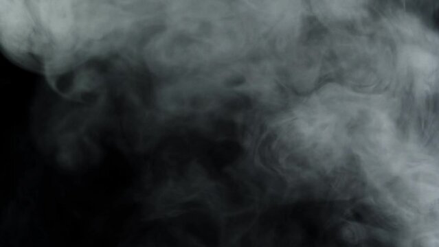 Smoke creates a transition effect in a video isolated on a black background, used to create video effects