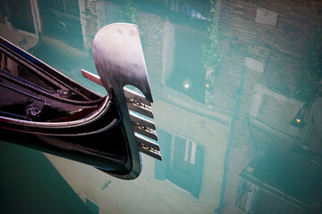 Gondola on turquoise water on canal in Venice © Lance Bellers