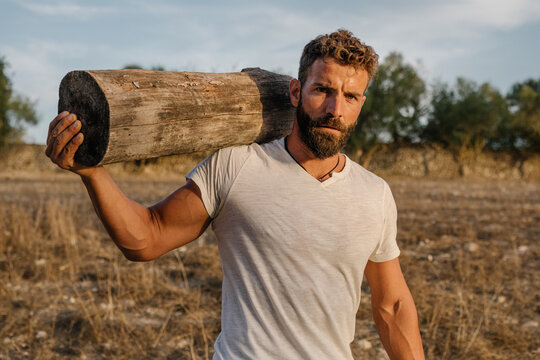 Strong male farmer with log