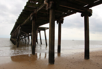 Wooden pier , view from below with beach and sea