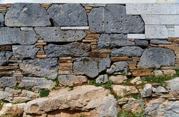 Texture of the ancient stone wall at Karthaia archeological site on Kea island, Greece