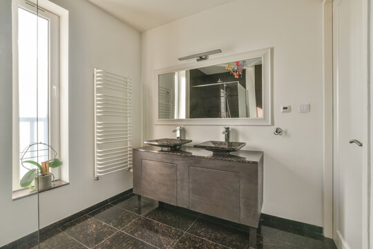 Bathroom with sink on cabinet and mirror heated towel rails