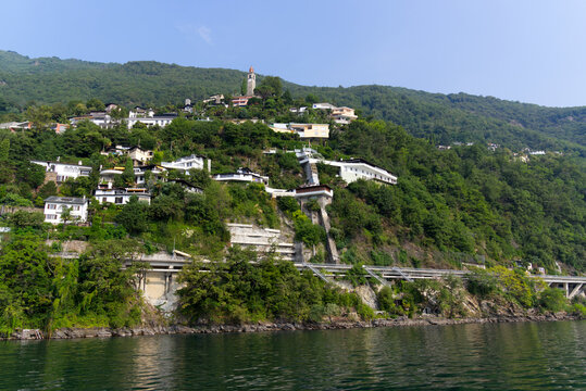 Scenic of village Ronco sopra Ascona with church tower on a sunny summer day. Photo taken July 25th, 2022, Ronco sopra Ascona, Switzerland.