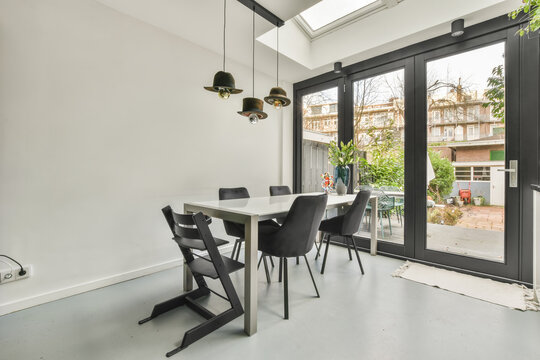 Modern Home With table and chairs next to a window