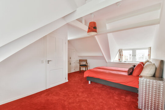single bed placed over red carpet in a modern bedroom