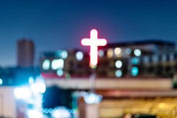 Defocused blur of building with cross