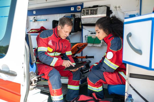 Paramedical professionals sitting in the medical emergency vehicle