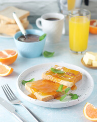 Sandwiches with marmalade, orange juice and coffee ready for breakfast	