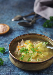 A bowl with chicken soup with pasta