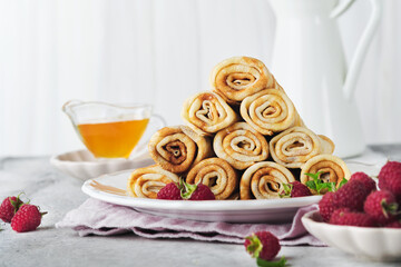 Pancakes. Stack of crepes or thin pancakes with berries, with raspberries and honey for breakfast. Homemade breakfast. Copy space. Selective focus.