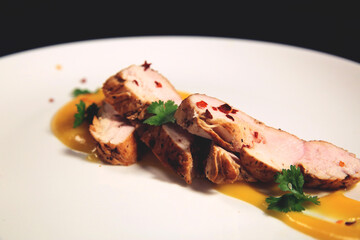 Roasted meat with sauce on grill or barbecue. Side view.