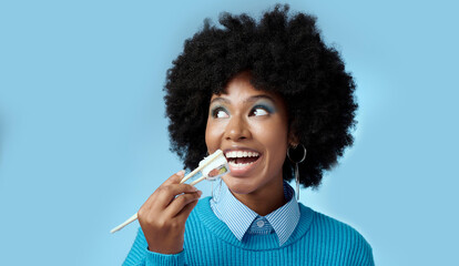 Happy, food and black woman with sushi in a studio eating with japanese chopsticks with mockup...