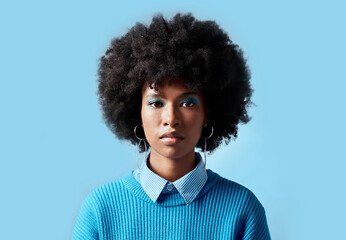 Fototapeta na wymiar Black woman afro, portrait and serious face for vision in focus against a blue studio background. African female model in cool fashion with cosmetic eyeshadow makeup on mockup
