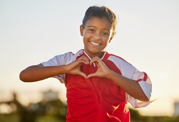 Heart hand and girl portrait at soccer game with passionate and happy sports player in Mexico. Mexican child football athlete in match showing appreciation, happiness and joy with love shape.