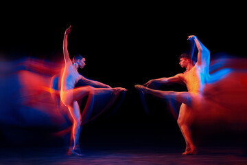 Confrontation between two. Couple of graceful and fragile ballet dancers in action isolated over black background in mixed neon light. Futurism, fantasy, miracle.