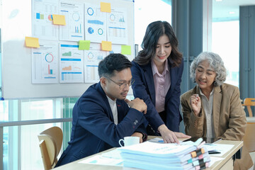 Professional Asian senior businesswoman or female boss in the meeting with her financial analysts...