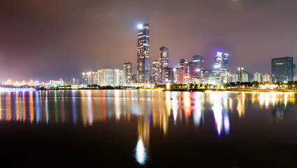 Fototapeta premium Office building reflected in the water at night