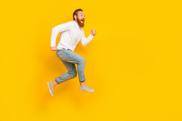 Fototapeta na wymiar Full body profile photo of beard man run promo wear shirt jeans shoes isolated on yellow color background