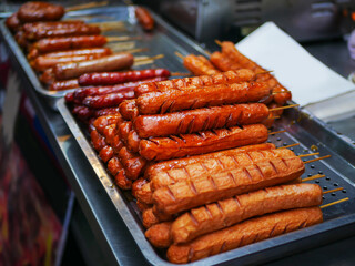 Close-up view of grilled sausages on the tray and selling in the night market.