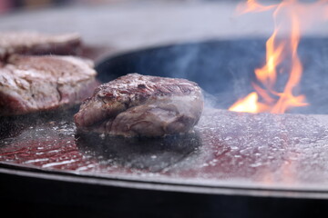 Steak with smoke and flame while preparing
