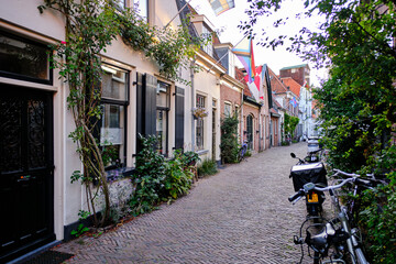 Fototapeta na wymiar Amersfoort, The Netherlands, August 8, 2022. Empty side streets with brick paving on a quiet summer’s evening.