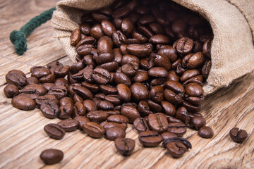 Dark roasted fragrant coffee beans in jute bag