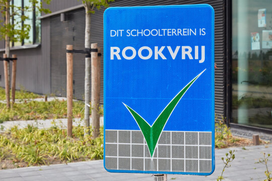 Sign on a public school with the Dutch text 'This school ground is smoke free' in Almere, The Netherlands on July 14, 2022