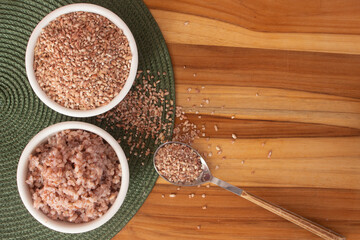two bowls filled with raw and cooked organic rice - food
