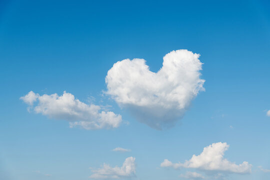 White heart shaped cloud in the blue sky