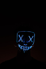 Blue Halloween led mask with black gradient background

