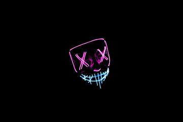 Purple and blue Halloween led mask with black background
