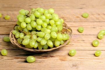bunch of grapes on wooden table