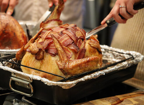 Picture turkey wrapped with bacon for thanksgiving dinner. Turkey with crispy bacon on top.