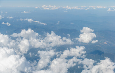 Top view cloudy mountains from a plane