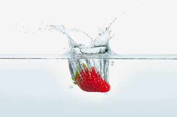 Strawberry splashing in water.