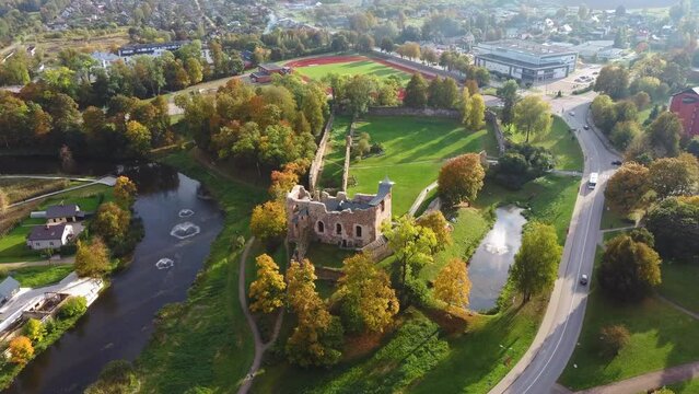 Aerial View of the Dobele City, Ancient Medieval Castle Park With Fontain Latvia. Aerial Panorama of Dobele City Sunny Autumn Day Landscape 4K.
Camera Moves Sideward