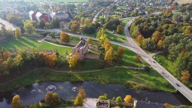 Aerial View of the Dobele City, Ancient Medieval Castle Park With Fontain Latvia. Aerial Panorama of Dobele City Sunny Autumn Day Landscape 4K.
Camera Moves Forward