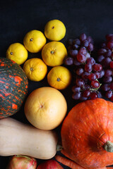 Various fresh and healthy autumnal fruit and vegetable. Top view, dark background.
