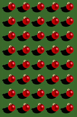 seamless red Christmas balls pattern on green background 