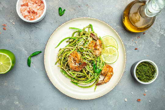 Zucchini raw pasta with pesto sauce and grilled shrimp cheese Parmesan, Restaurant menu, dieting, cookbook recipe top view